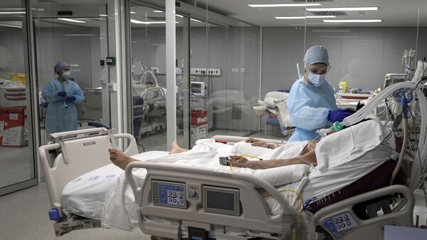 Una enfermera cuida de un paciente en el Hospital Zendal de Madrid - Sputnik Mundo