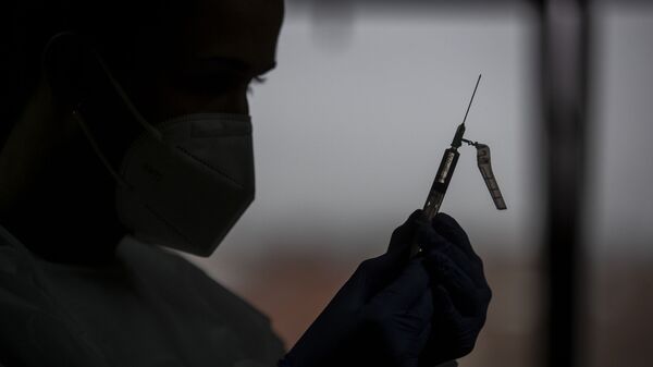 Un profesional de la salud prepara una vacuna - Sputnik Mundo