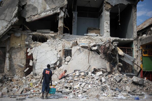 Haitianos buscan entre los escombros de un edificio derruido por el terremoto de magnitud 7,0 en la escala de Richter que se registró el 12 de enero de 2010, con epicentro a 15 kilómetros de la capital, Puerto Príncipe.  Murieron más de 316.000 personas, hubo más de 350.000 heridos y cerca de 1,5 millones de personas quedaron sin hogar. - Sputnik Mundo