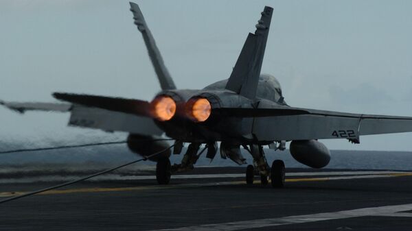Un F/A-18C Hornet realiza un aterrizaje a bordo del USS John C. Stennis - Sputnik Mundo
