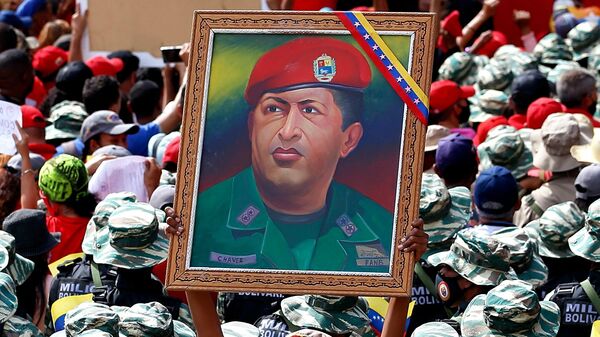 Miliciana porta un cuadro con la imagen de Hugo Chávez durante el Día de la Milicia Nacional Bolivariana - Sputnik Mundo