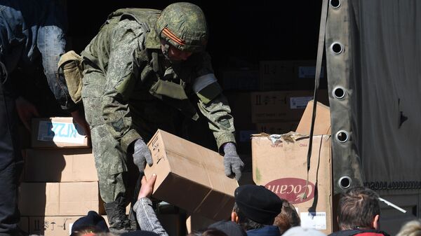 Un militar ruso entrega ayuda humanitaria a la población ucraniana - Sputnik Mundo