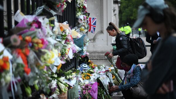 Miles de personas acuden al palacio de Buckingham para lamentar la muerte de la reina Isabel II - Sputnik Mundo