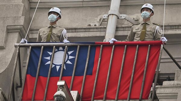 Policías militares resguardan una bandera de Taiwán. - Sputnik Mundo