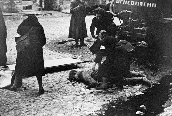 Paramédicas ofrecen primeros auxilios a víctimas de bombardeos en Leningrado (actual San Petersburgo), septiembre de 1941. - Sputnik Mundo