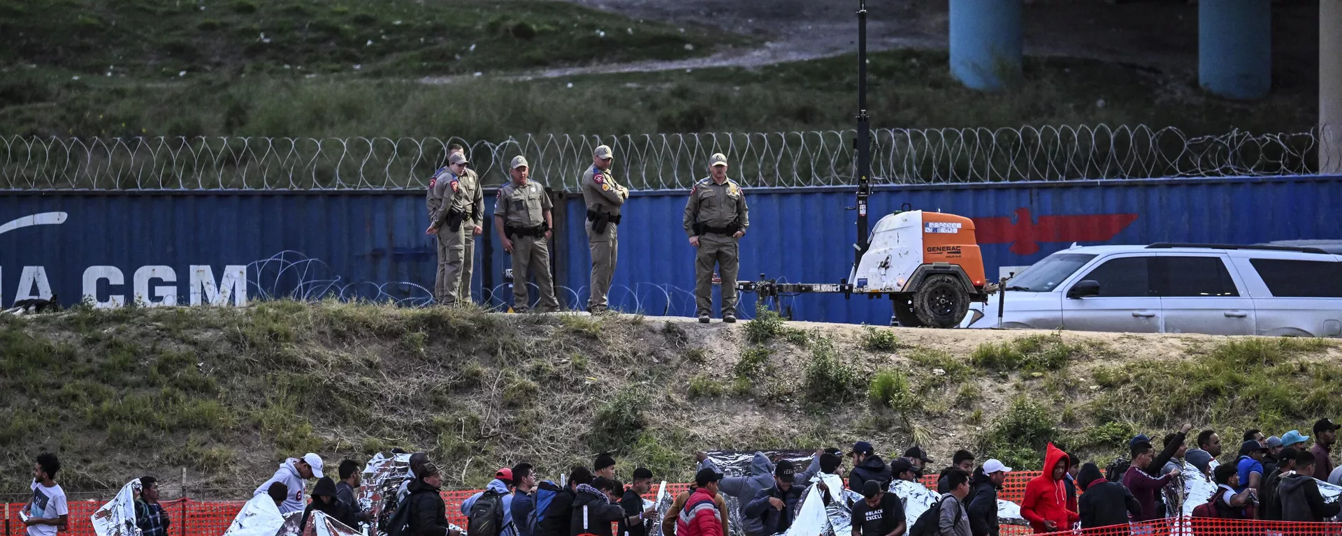 Agentes de aduanas y protección fronteriza hacen guardia mientras los inmigrantes esperan a ser procesados en un centro de tránsito de la Patrulla Fronteriza de Estados Unidos después de cruzar la frontera desde México en Eagle Pass, Texas, el 22 de diciembre de 2023. - Sputnik Mundo, 1920, 28.01.2024