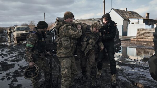 Soldados ucranianos ayudan a un compañero herido  - Sputnik Mundo