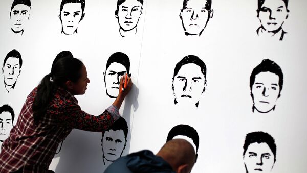 Miembros de Amnistía Internacional participan en una manifestación en recuerdo de los 43 normalistas desaparecidos en Ayotzinapa, México. - Sputnik Mundo