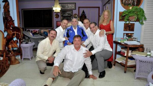 Cuba's former President Fidel Castro (C, in blue jacket) and his wife Dalia Soto Del Valle (R, in red dress) pose for a photograph with the so-called Cuban Five Ramon Labanino (C, front), Fernando Gonzalez (L), Gerardo Hernandez (2nd L), Antonio Guerrero (3rd R) and Rene Gonzalez (2nd R) in this picture provided by Cubadebate - Sputnik Mundo
