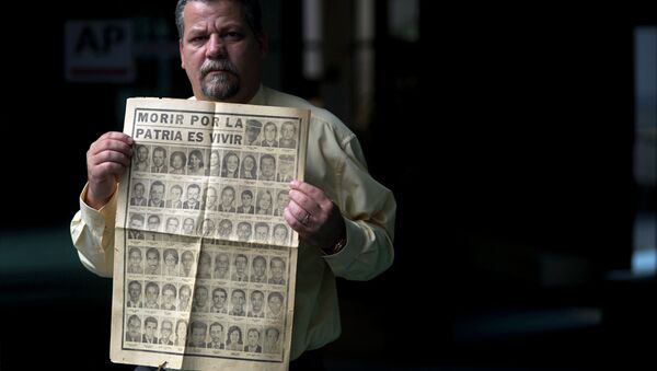 Camilo Rojo, whose father died when he was five-years-old in the Cubana Airlines plane that exploded in 1976 while flying from Barbados to Cuba, holds up the Granma newspaper that published the news of the bombing in Havana, Cuba. - Sputnik Mundo