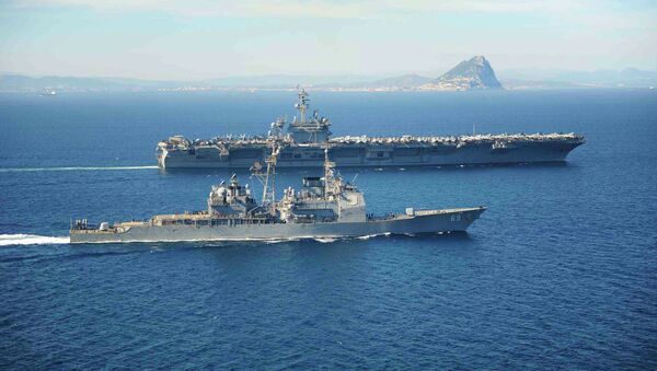 The Ticonderoga-class guided missile cruiser USS Vicksburg escorts the Nimitz-class aircraft carrier USS Theodore Roosevelt (top) as they pass the Rock of Gibraltar in the Mediterranean Sea - Sputnik Mundo