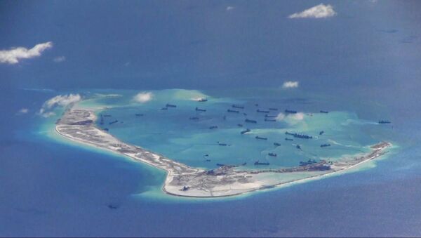 Chinese dredging vessels are purportedly seen in the waters around Mischief Reef in the disputed Spratly Islands, image from video taken by a P-8A Poseidon - Sputnik Mundo