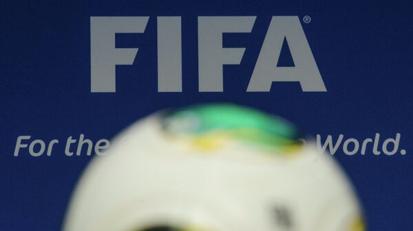 The FIFA logo is pictured behind a ball during the press conference following the meeting of the FIFA executive comittee in Zurich - Sputnik Mundo