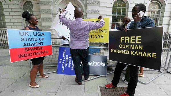Manifestantes sostienen carteles exigiendo la liberación de jefe de inteligencia de Ruanda Karenzi Karake en Londres - Sputnik Mundo