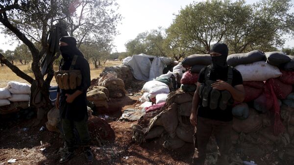 Members of al Qaeda's Nusra Front stand in front of piled sandbags near the two Shi'ite Muslim towns of al-Foua and Kefraya in northwestern Syria - Sputnik Mundo