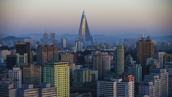 The 105-storey Ryugyong Hotel, the highest building under construction in North Korea, is seen behind residential buildings in Pyongyang, North Korea, early October 9, 2015 - Sputnik Mundo