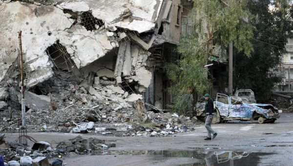 A man walks in a devastated street of the eastern Syrian town of Deir Ezzor on February 15, 2014. - Sputnik Mundo