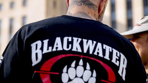 A former member of Blackwater joines family members, friends, and supporters of four former Blackwater security guards outside the federal court in Washington, Monday, April 13, 2015 - Sputnik Mundo