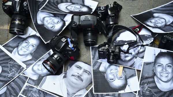 View of photos of killed journalists and cameras outside the Veracruz state representation office during a journalists protest in Mexico City on February 11, 2016.  - Sputnik Mundo