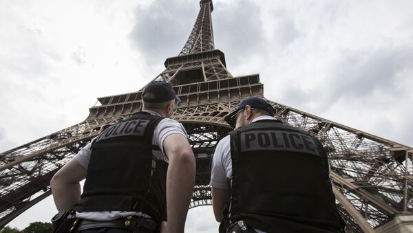 French riot police officers patrol under the Eiffel Tower, near the entrance of the soccer fan zone, prior to the Euro 2016 Group A soccer match between France and Romania, in Paris, Friday, June 10, 2016 - Sputnik Mundo