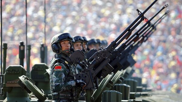 Soldiers of the People's Liberation Army (PLA) of China arrive on their armoured vehicles at Tiananmen Square during the military parade marking the 70th anniversary of the end of World War Two, in Beijing, China, September 3, 2015 - Sputnik Mundo