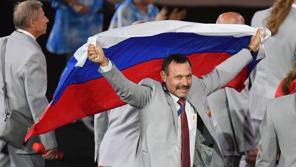 Andrei Fómochkin con la bandera rusa - Sputnik Mundo