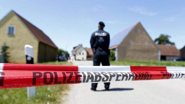 A police tape and a German police officer are seen in Tiefenthal near Ansbach, Germany, July 10, 2015 - Sputnik Mundo