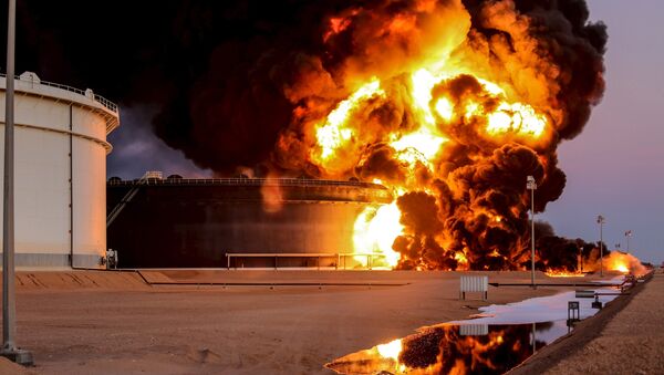 Fire rises from an oil tank in the port of Es Sider, in Ras Lanuf, Libya, in this file picture taken January 4, 2016. - Sputnik Mundo