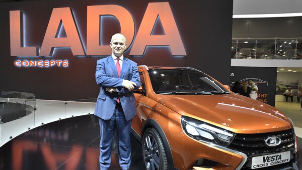 AvtoVAZ CEO French businessman Nicolas Maure poses in front of a Lada Vesta car - Sputnik Mundo