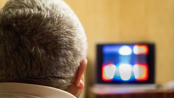 Un hombre mirando la televisión (imagen referencial) - Sputnik Mundo