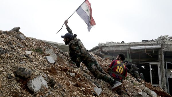 Militar sirio emplaza la bandera nacional de Siria durante los combates en Alepo oriental - Sputnik Mundo
