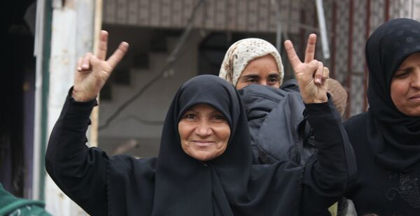 Una mujer celebra la liberación de Hanano. Una mujer celebra la liberación de Hanano. - Sputnik Mundo