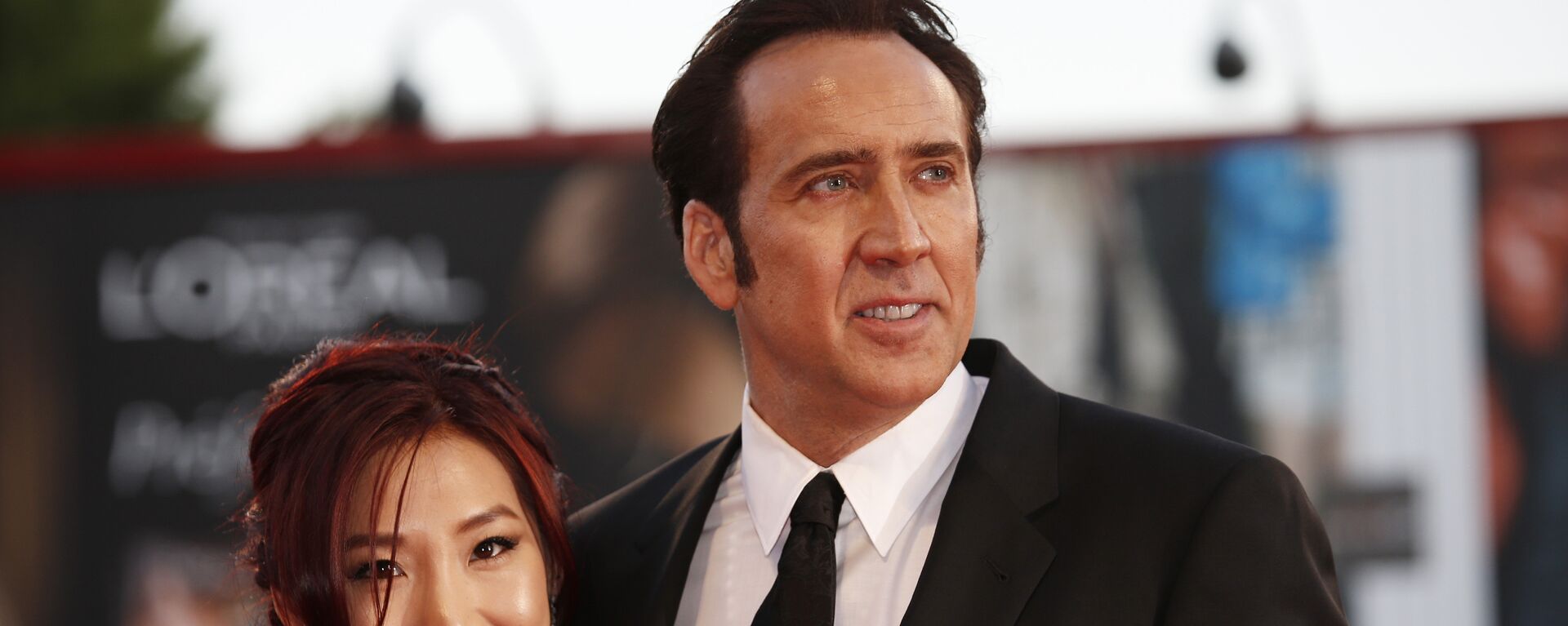 Actor Nicolas Cage, right, and his wife Alice Kim arrive for the screening of the film Joe at the 70th edition of the Venice Film Festival held from Aug. 28 through Sept. 7, in Venice, Italy, Friday, Aug. 30, 2013 - Sputnik Mundo, 1920, 28.10.2021