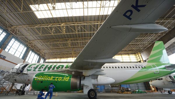 This picture taken on April 4, 2013 in Tangerang shows Indonesian technicians from GMF (Garuda Maintenance Facilities), a subsidiary of national carrier Garuda Indonesia maintaining a Citilink - Sputnik Mundo
