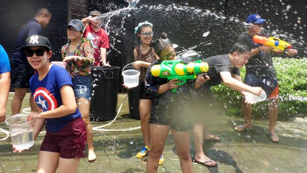 Juegos con pistolas de agua durante la celebración del Año Nuevo Budista en Thailand - Sputnik Mundo