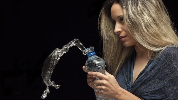 Una mujer con la botella de agua - Sputnik Mundo