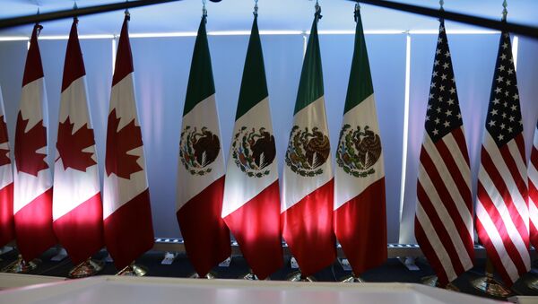 National flags representing Canada, Mexico, and the US are lit by stage lights at the North American Free Trade Agreement, NAFTA, renegotiations, in Mexico City, Tuesday, Sept. 5, 2017. - Sputnik Mundo