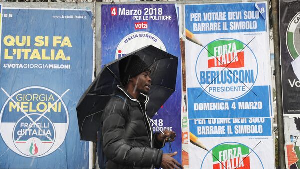 Un inmigrante africano pasa ante carteles electorales para las elecciones generales de Italia - Sputnik Mundo