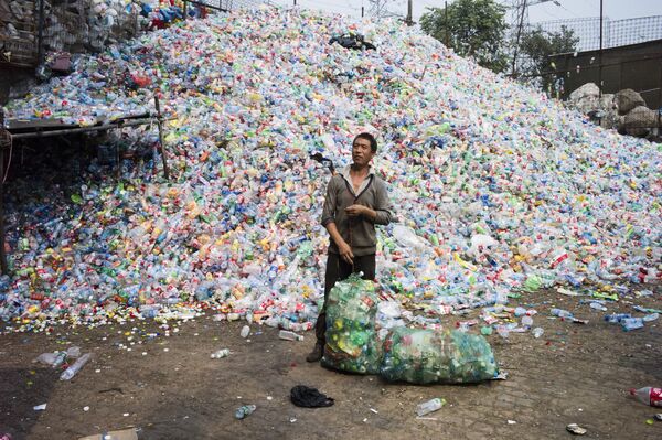 Un chino recicla botellas de plástico en el pueblo de Dong Xiao Kou, a las afueras de Pekín (China) Un chino recicla botellas de plástico en el pueblo de Dong Xiao Kou, a las afueras de Pekín (China) - Sputnik Mundo