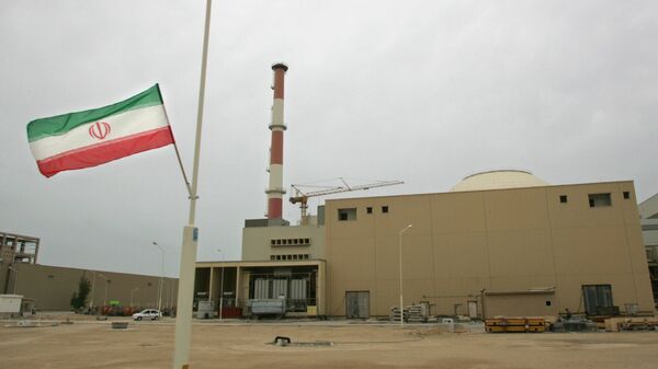 La bandera de Irán junto a la planta nuclear de Bushehr - Sputnik Mundo