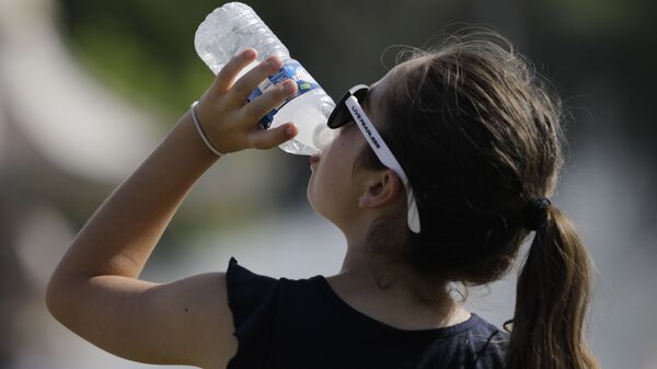 Una joven bebe agua (imagen referencial) - Sputnik Mundo