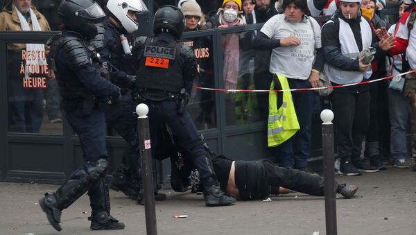 Policía arrestando a un manifestante durante las manifestaciones de los chalecos amarillos en París, Francia - Sputnik Mundo