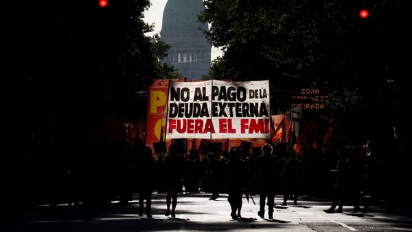 Manifestantes con un cartel en contra del FMI en Buenos Aires - Sputnik Mundo