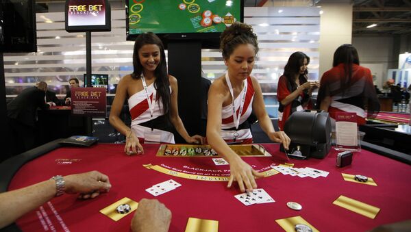 Attendants conduct play with the visitors over a Black Jack gaming table during the Global Gaming Expo Asia in Macau - Sputnik Mundo