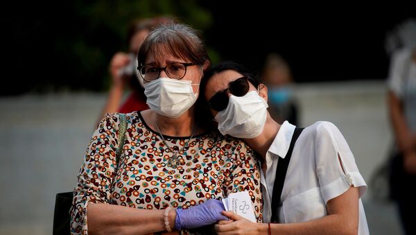 Dos mujeres con mascarillas durante brote de coronavirus en España - Sputnik Mundo
